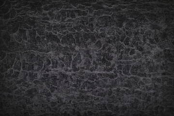 Texture of black polished concrete background. Dark plaster wallpaper with rough cement texture. Empty grunge wall concept or floor backdrop. Abstract surface mockup. Top view, close up, copy space