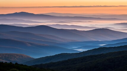 Fototapeta premium Serene mountain layers bathed in warm sunrise hues with gentle morning mist