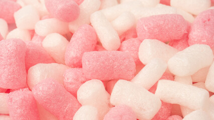 Pink and white box filler as a background. Top view.