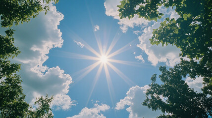 The sun shines through the clouds, creating a bright blue sky with white clouds. A lens flare is visible in front of it. Trees are visible in the distance.