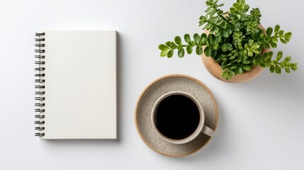 Minimalist desk with notebook, coffee, and plant, clean flat lay, white background