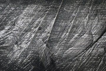 Abstract background. Texture of aged weathered wooden surface with pronounced deep cracks and irregularities.
