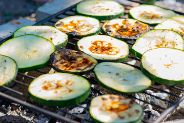 a lot of mushrooms and zucchini are fried on the grill. High quality photo