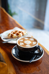 Hot coffee latte with latte art milk foam in cup mug and Homemade Belgian Waffles with honey on...