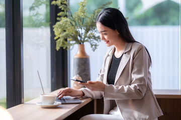 Asian freelance people business female talking making using casual working with laptop computer and coffee at home in the living room indoors artificial rose bouquet of red and pink roses rose vase