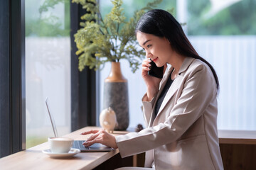 asian freelance people Beautiful business female talking making using casual working with laptop computer for browsing internet, chatting and blogging and smartphone,notebook in coffee shop.