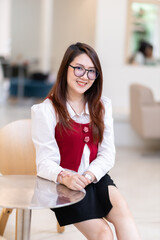 Portrait of beautiful happy Smiling asian woman relaxing sitting in cafe interior in coffee shop background