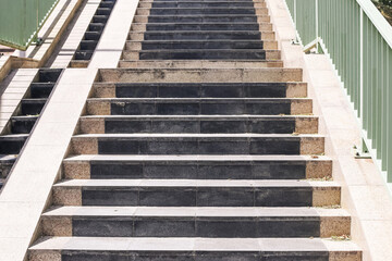 Modern concrete staircase detail. Outdoor urban steps with handrails. Clean architectural lines and symmetry. Daylight construction design. Contemporary city infrastructure element.