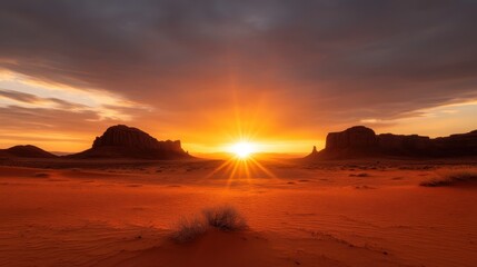 Fototapeta premium A stunning sunset illuminates the desert landscape, casting an ethereal glow over the sandy dunes and rock formations, showcasing nature's incredible beauty.