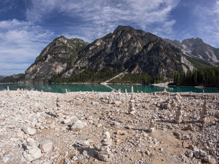 Balanced stack of zen stones with mountains and lake in the background. Meditation relaxation concept.