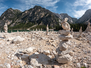 Balanced stack of zen stones with mountains and lake in the background. Meditation relaxation concept.