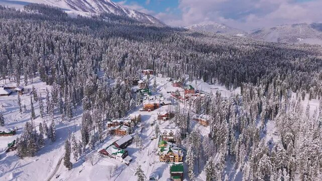 Aerial footage of winter architecture shining under snow-covered sky.