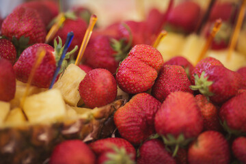 Sun kissed berries rest atop pineapple dreams, a tropical bounty ready for the garden party at...