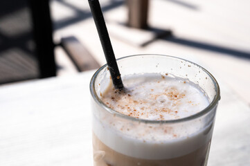 Glas with café Latte and straw in Beringen, Limburg, Belgium