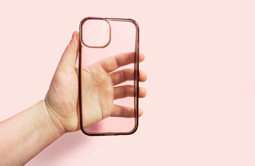 Clean transparent phone case displayed in hand against soft pink background, emphasizing its sleek design and suitability for everyday smartphone use.