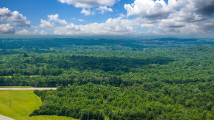 aerial shot of vast miles of lush green trees and homes at the Nashville Superspeedway in Lebanon...