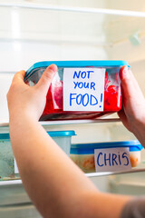 Dramatic and angry sticker on meal prep containers in work fridge. Great for office themed social media content, viral workplace trends and humor.