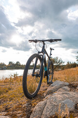 Mountain bike on rocky trail under dramatic sky in summer
