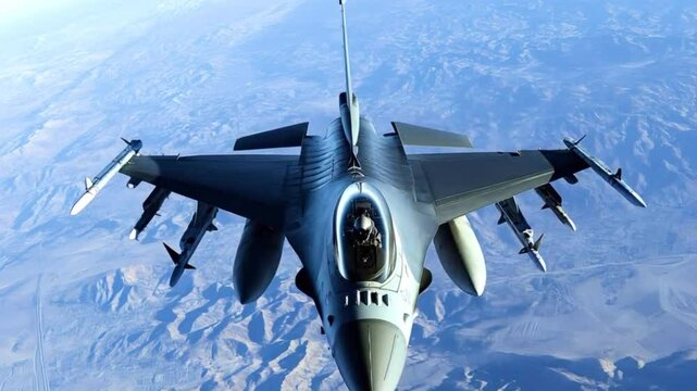 Military fighter jet f 16 fighting falcon soaring above rugged desert mountains, carrying advanced weaponry and showcasing air superiority through powerful aerial presence