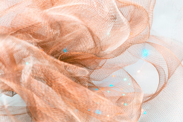 Copper Mesh Fabric with Blue Accents – Abstract Close-Up of Flowing Textile in Soft Waves and...