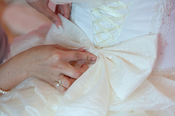 Bride adjusting her elegant wedding dress
