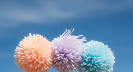 Pastel Pom Poms Against Blue Sky: Playful, Crafty, and Dreamy