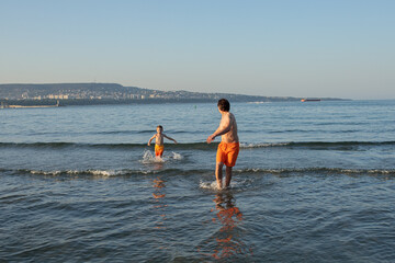 Happy father and son at sea on the beach in summer. Father's Day.