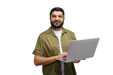 Man in a green shirt smiles while holding an open laptop, fingers poised over the keys, ready to work on a sunny afternoon in the office