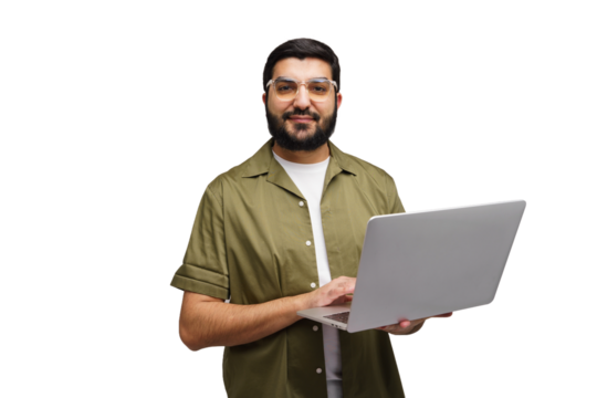 Man in a green shirt smiles while holding an open laptop, fingers poised over the keys, ready to work on a sunny afternoon in the office