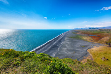 Impressive View of Kirkjufjara black sand beach from Dyrholaey promontory on Atlantic South Coast