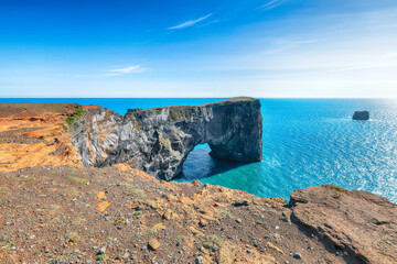 Impressive andscape with unique basalt arch on Dyrholaey Nature Reserve on Atlantic South Coast.