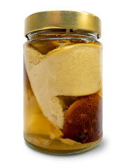 Chopped edible porcini mushrooms canned in oil in glass jar isolated