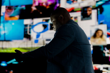 Black male person appears immersed in information overload, depicting the crisis and manipulation...