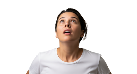 A woman in a white shirt looking upwards with her mouth slightly open against a black background space on transparent background
