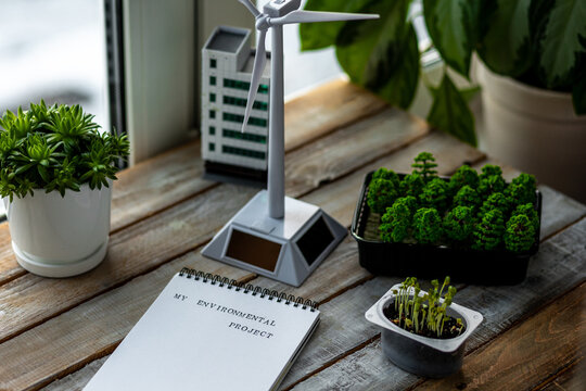 School environmental project, ecology lesson. Little boy is doing a study on sustainability, eco friendly living. Renewable energy, green city, urban planning. Biodiversity, plants