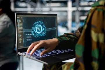 Close up of army tech expert in data center running simulations with military grade defense...