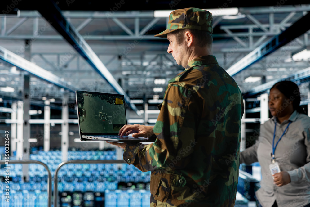 Poster data center army officer in uniform types commands on laptop keyboard, tracking missiles. military s