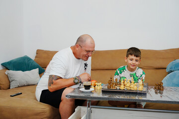Father and son playing chess and enjoying quality time together