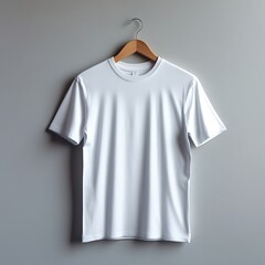 A white cotton T-shirt hanging on a wooden hanger, centered against a plain light grey studio background, well-lit with soft shadows. Front-facing view, high resolution image.