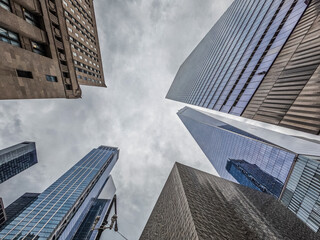 Looking up at Manhattan skyscrapers on cloudy day