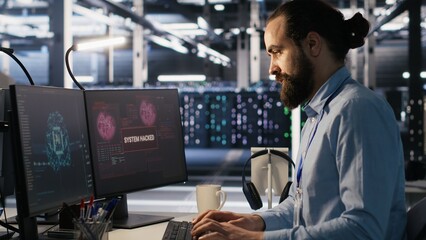 Server farm worker trying to fix hacked equipment systems and protect equipment. Data center...