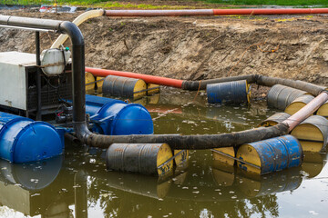 Pumping Equipment and Floating Drums in Water at a Construction Site