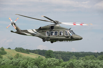 military transport helicopter flies at low altitude above the ground