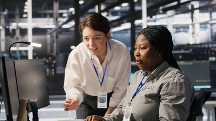 Cheerful data center technicians satisfied with results after collaborating on AI automation...