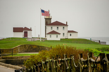 Watch Hill Light in Rhode Island Surrounded by a Stone Seawall