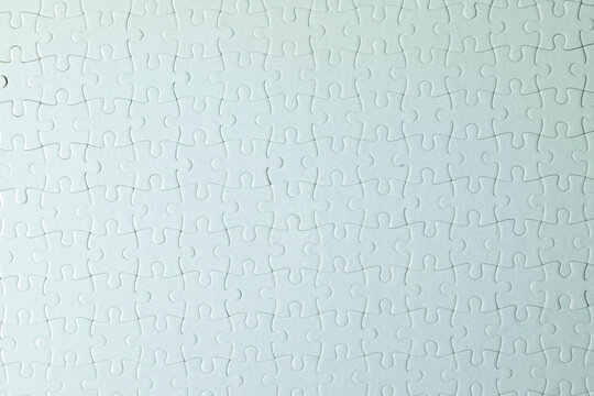 Top view Seamless texture of white jigsaw puzzle pieces fully connected idea for abstract,background.,Minimalist background.,idea for overlaying text or graphic,collaboration.,Clean and simple design.