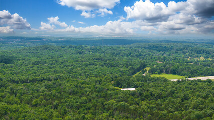aerial shot of vast miles of lush green trees and homes at the Nashville Superspeedway in Lebanon...