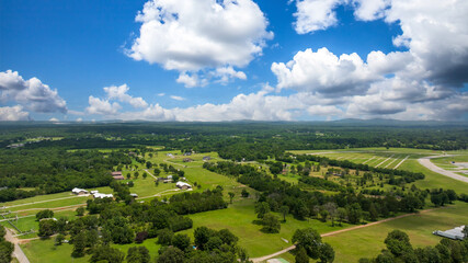 aerial shot of vast miles of lush green trees and homes at the Nashville Superspeedway in Lebanon...