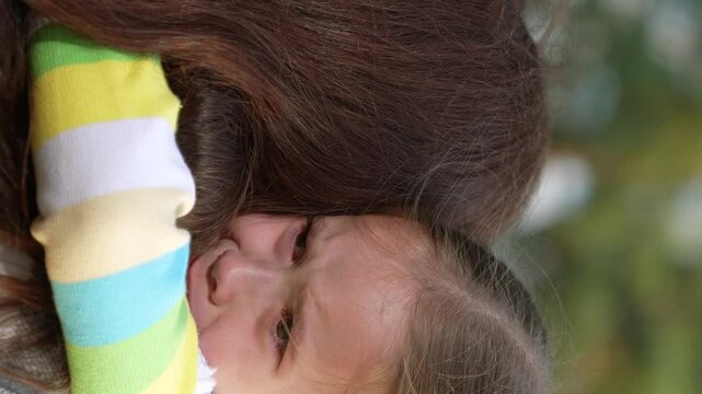 little child cries, tears child face, mother calms capricious kid girl daughter, happy family, wipe tears face, hug kid park, maintaining confidence, mother support, child face tears, learning cope