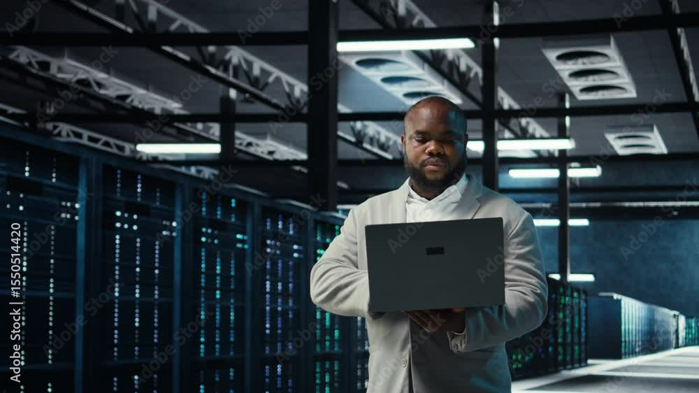 Poster engineer walking in data center using ai automation during maintenance session. african american ser